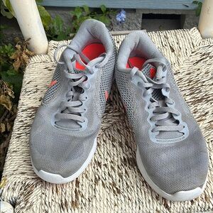 Woman’s Gray with orange Nike Revolution Women’s Athletic Shoes Sz 8 Gently Used